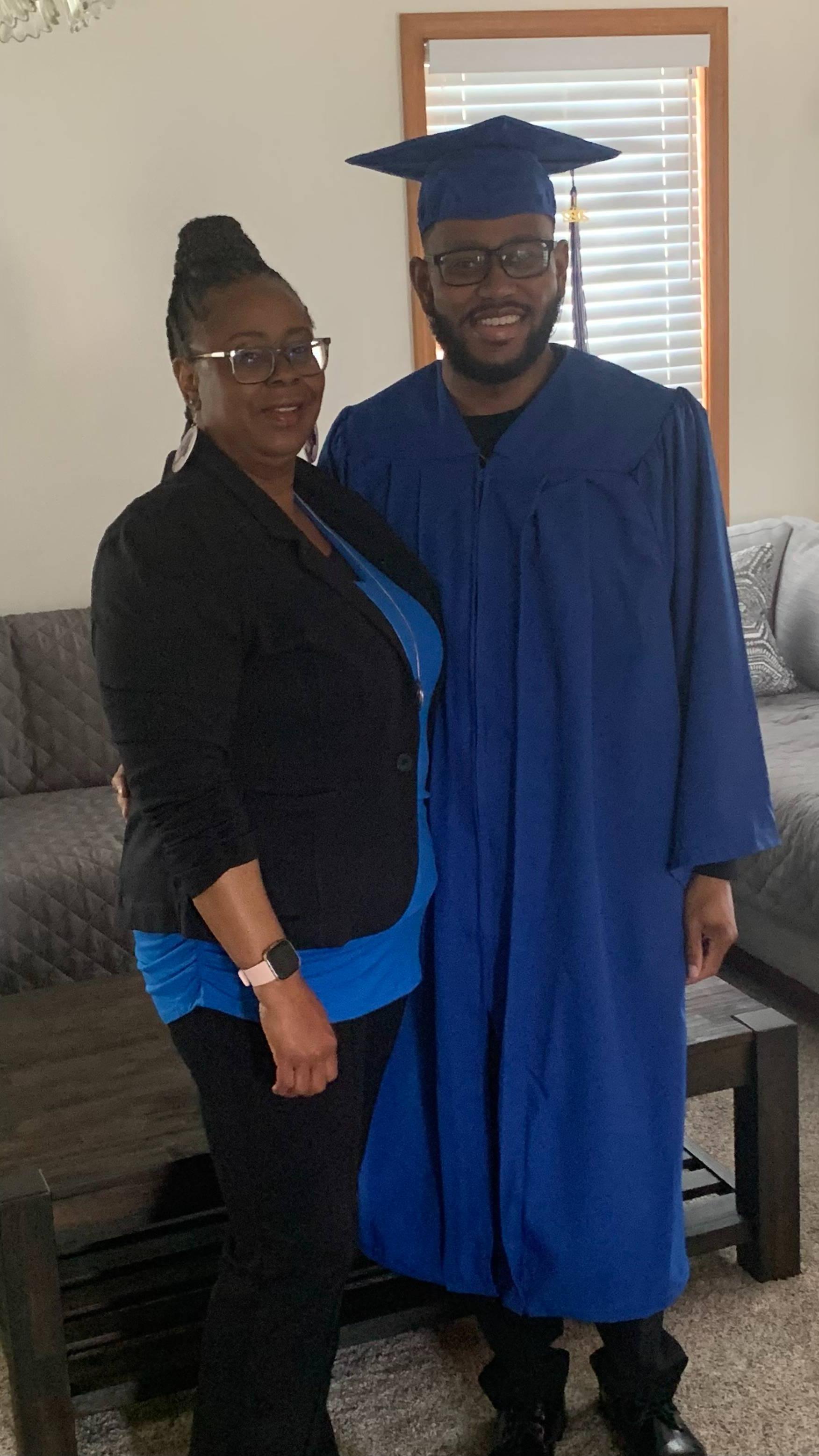 Tina Lee standing and smiling with her son, Daniel, in his cap and gown